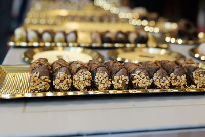 Italian sweet dessert, traditional sicilian cannoli with nuts and chocolate cream.