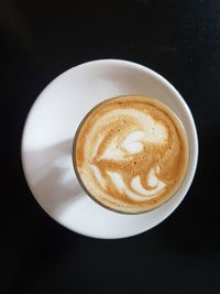 Close-up of coffee cup against black background