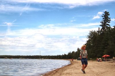 Woman on beach against sky
