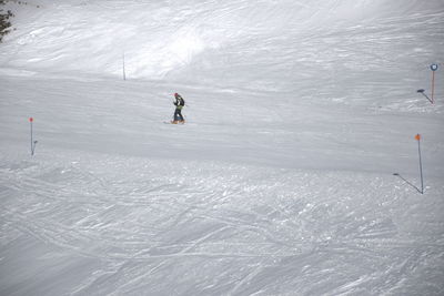 High angle view of man skiing on snow covered field