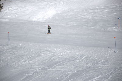 People skiing on snow covered land