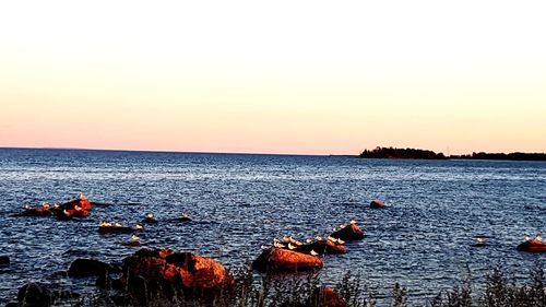 Scenic view of sea against clear sky during sunset