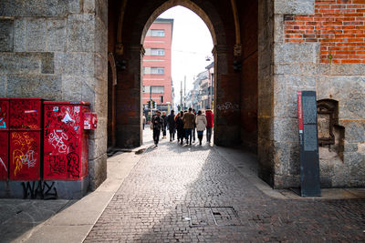 People walking in front of historic building