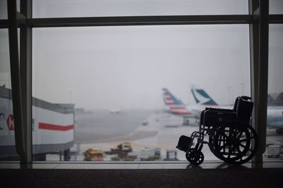 Wheelchair by window in airport waiting room