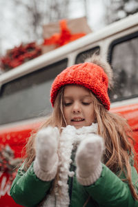 Portrait of smiling young woman standing in city