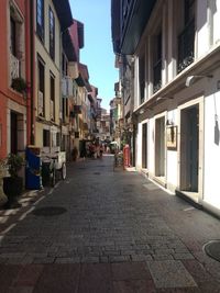 Empty alley amidst buildings in city