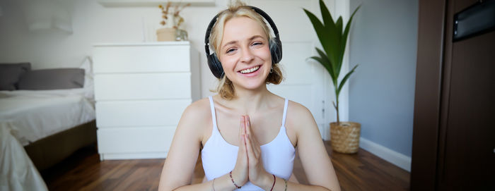 Portrait of young woman sitting at home