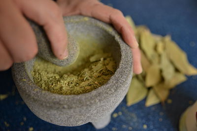 Close-up of hand crushing bay leaves