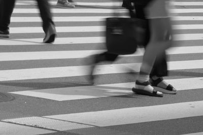Low section of people walking on street