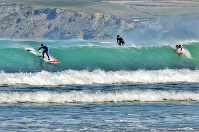 Surfers on wave