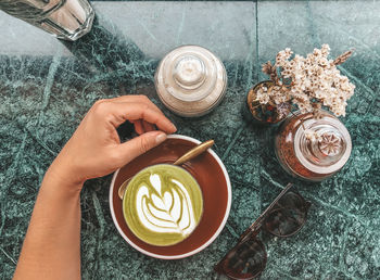 High angle view of matcha latte cup on table