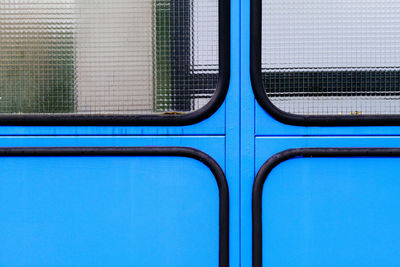 Detail view on blue wall with safety glass