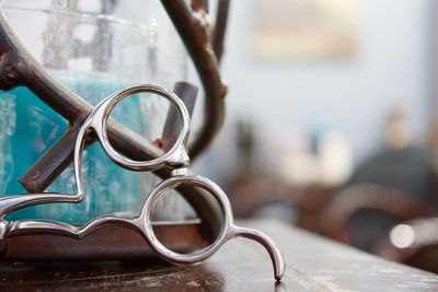 Cropped image of scissors on table at shy hair studio