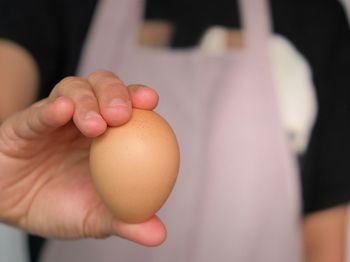 Close-up midsection man brown egg