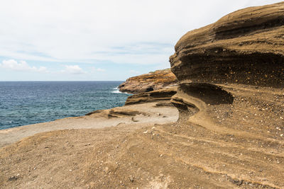 Scenic view of sea against cloudy sky