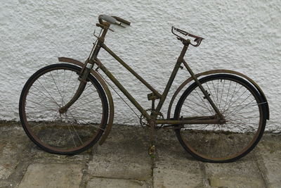 Bicycle parked against wall