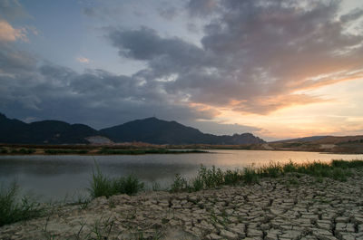 Scenic view of lake against sky during sunset