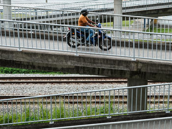 Rear view of man riding bicycle