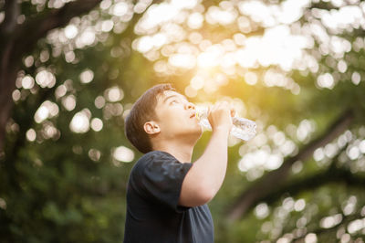 Young athlete drinking water 