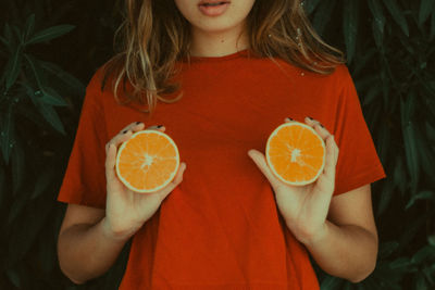 Close-up of young woman holding drink