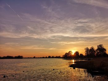 Scenic view of lake against sky during sunset