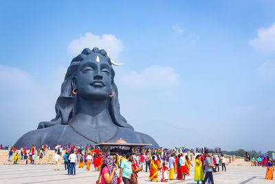 Statue of people against sky