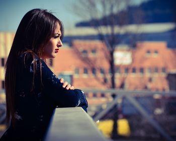 Close-up of girl standing against sky