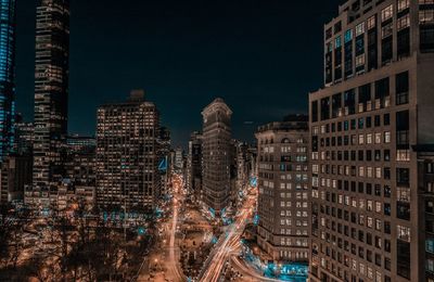 Aerial view of city lit up at night