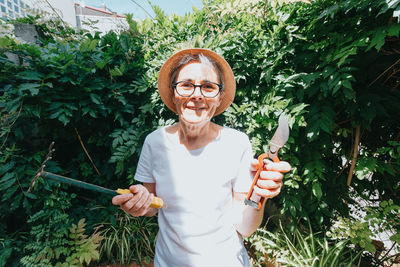 Portrait of smiling woman against plants