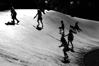 High angle view of people skateboarding on snow