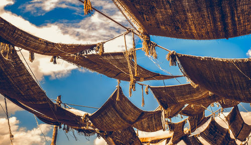 Low angle view of cross hanging against sky