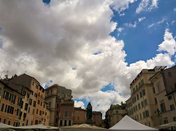 Low angle view of building against cloudy sky