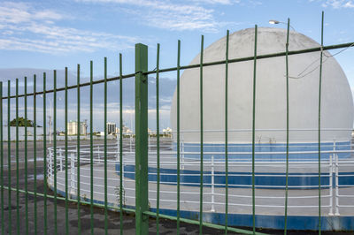 Metal fence against blue sky