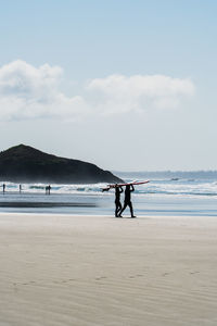 Man on beach against sky