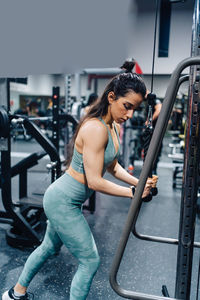 Young woman exercising in gym