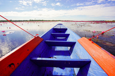 Close-up of boat moored on lake