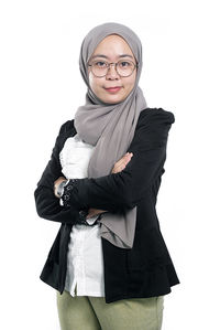 Portrait of beautiful young woman against white background