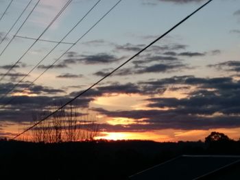 Silhouette landscape against sky during sunset