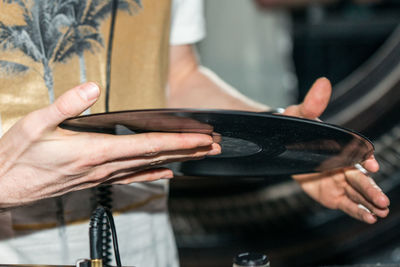 Midsection of man holding record