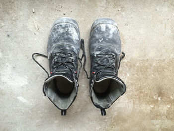 Close-up of dirty shoes on floor
