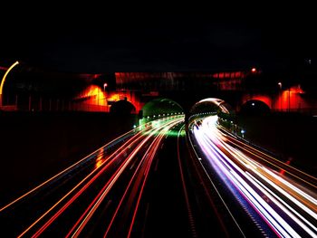 Light trails on road in city at night