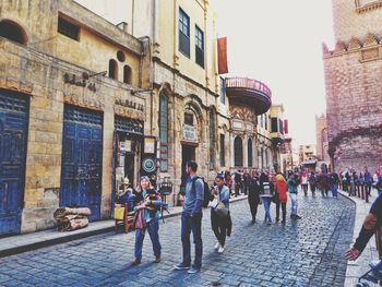 Group of people standing in front of buildings