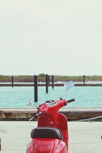 Red boat on sea against clear sky