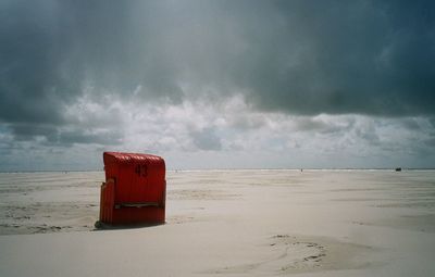 Lifeguard hut on beach against sky