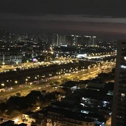 Illuminated cityscape against sky at night