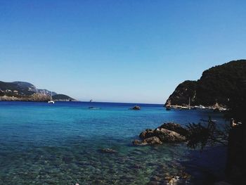 Scenic view of sea against clear blue sky