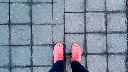 Low section of person standing on tiled floor