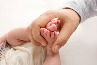 Close-up of hands holding baby hand