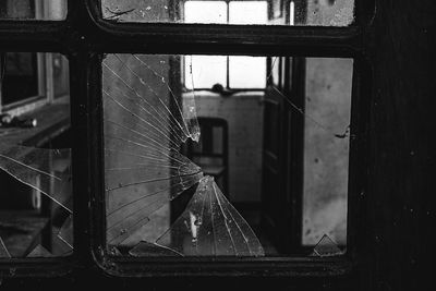 Close-up of broken window and chair