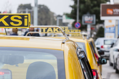 Close-up of yellow taxis on street